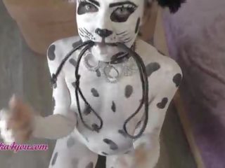 Attractive young female In Dalmatian Costume Playfully Rides Cavalier's Big putz